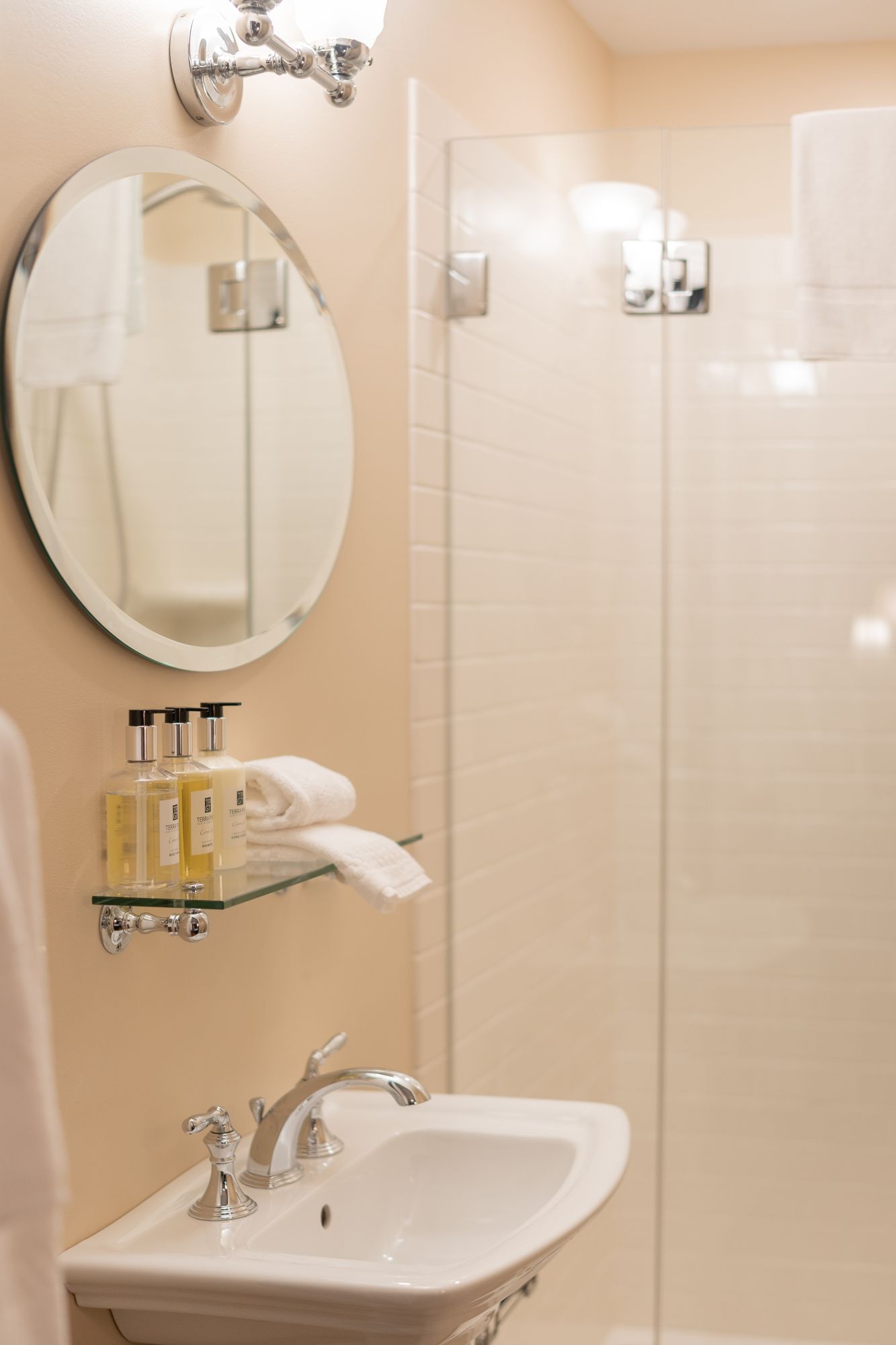 A bathroom with a sink a mirror and a shower