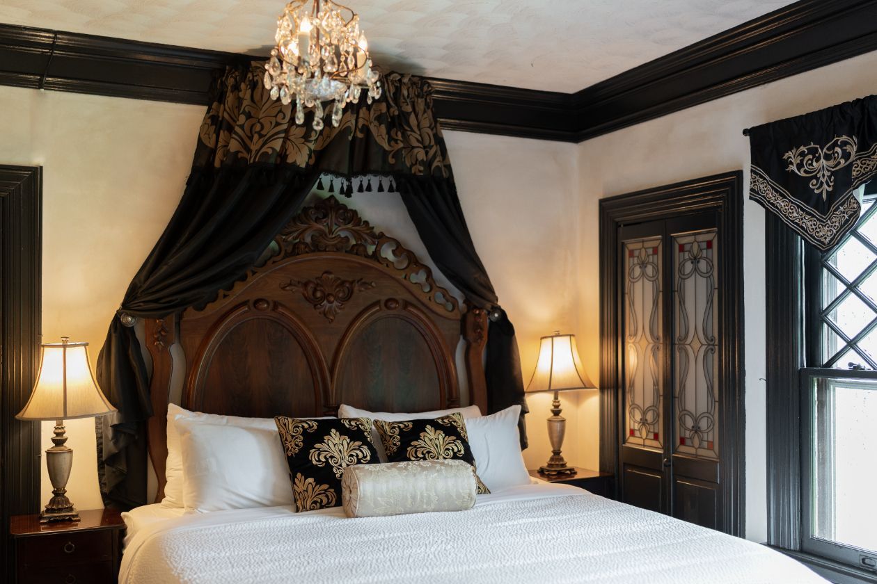 A romantic bedroom at a New England Country Inn with a bed crown and a vintage  chandelier