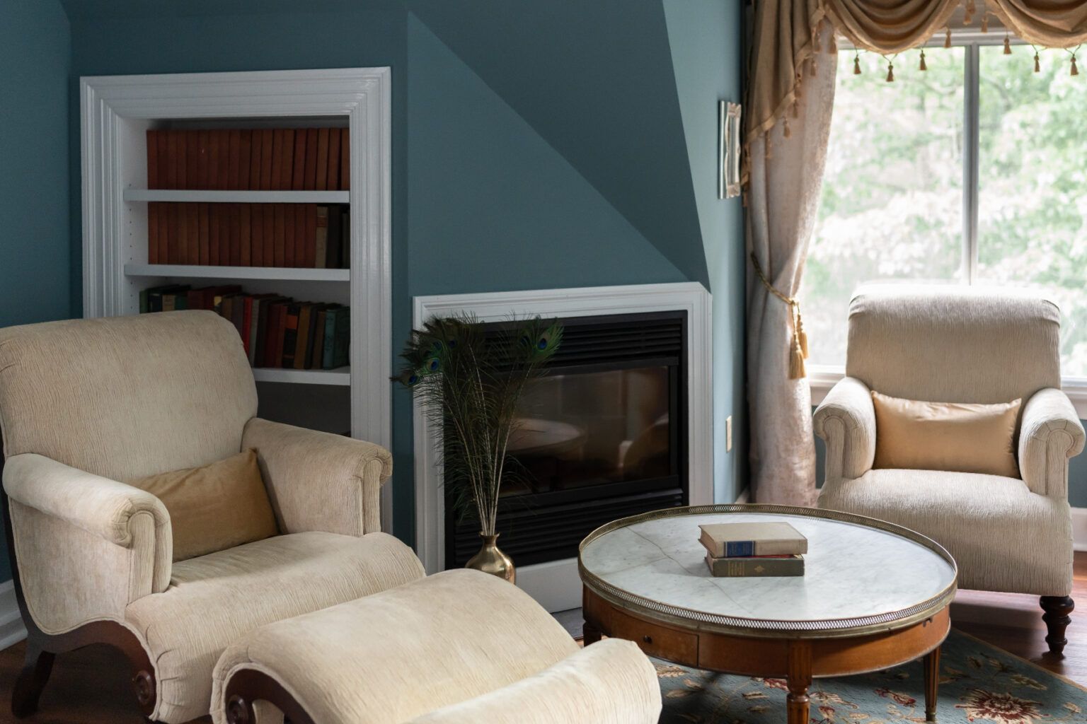 A sitting area at a New England Country Inn with two chairs, a coffee table, and a fireplace.
