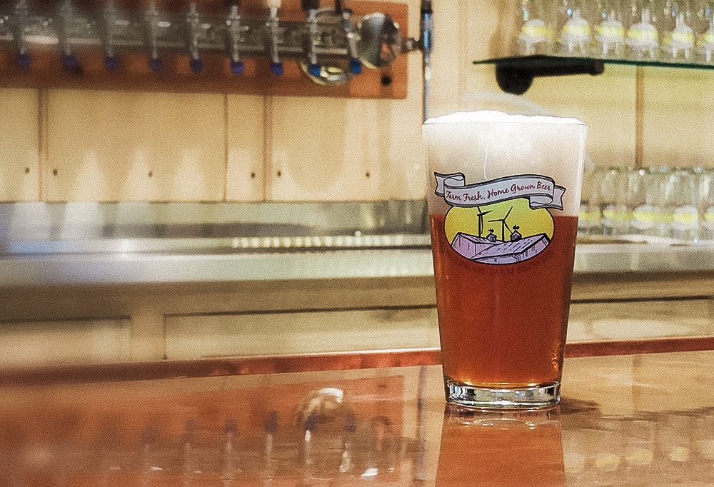 A glass of la la beer sits on a counter