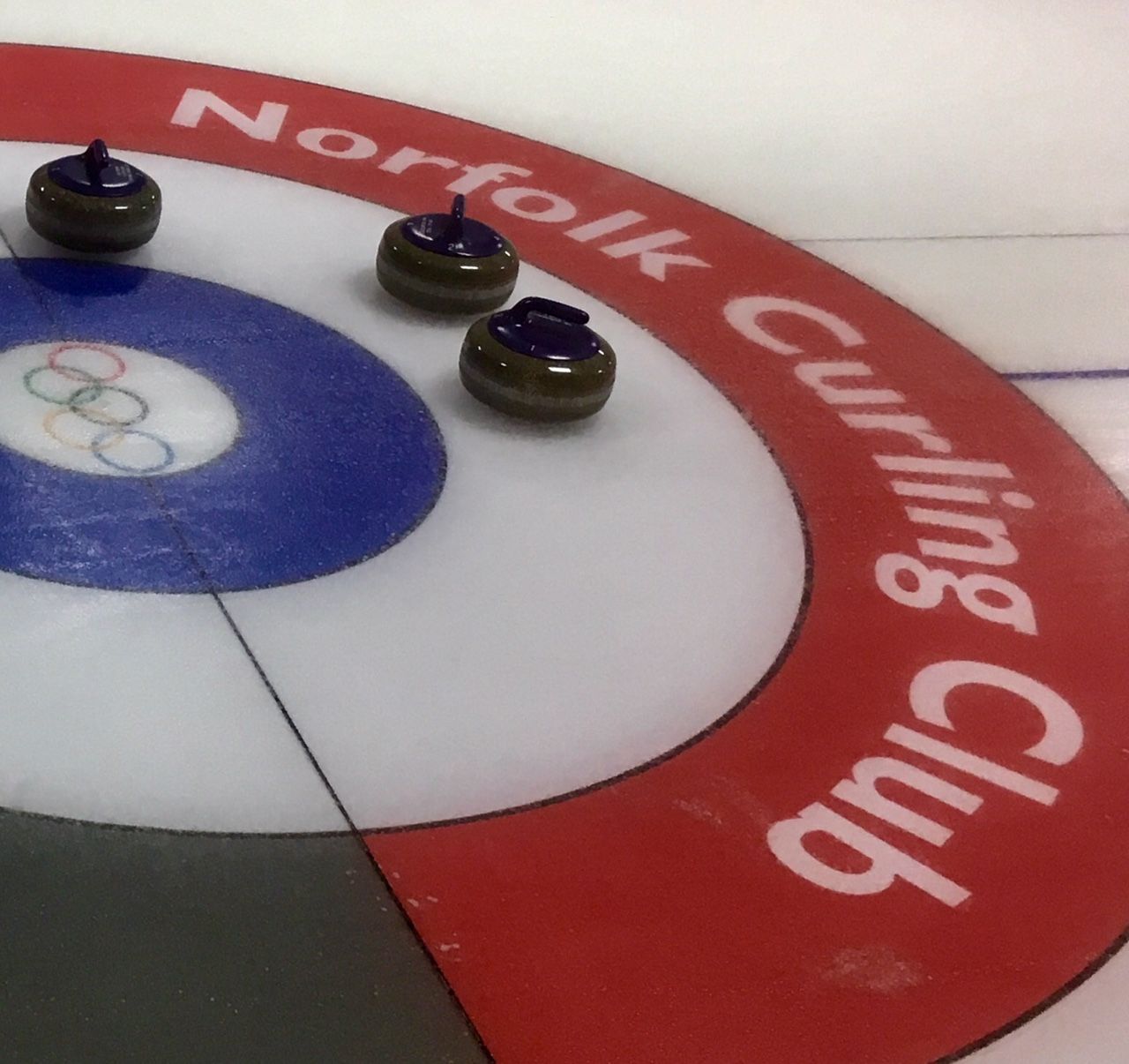 A curling rink with the words norfolk curling club on it