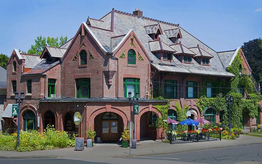 A large brick building with a roof that has shingles on it