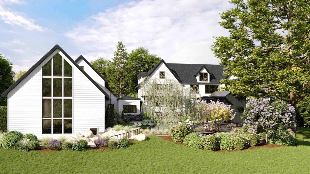 A white house with a black roof is sitting on top of a lush green field.