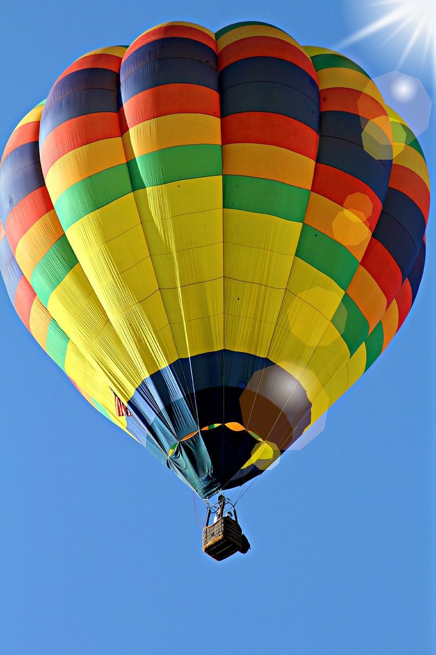 A colorful hot air balloon is flying in the sky