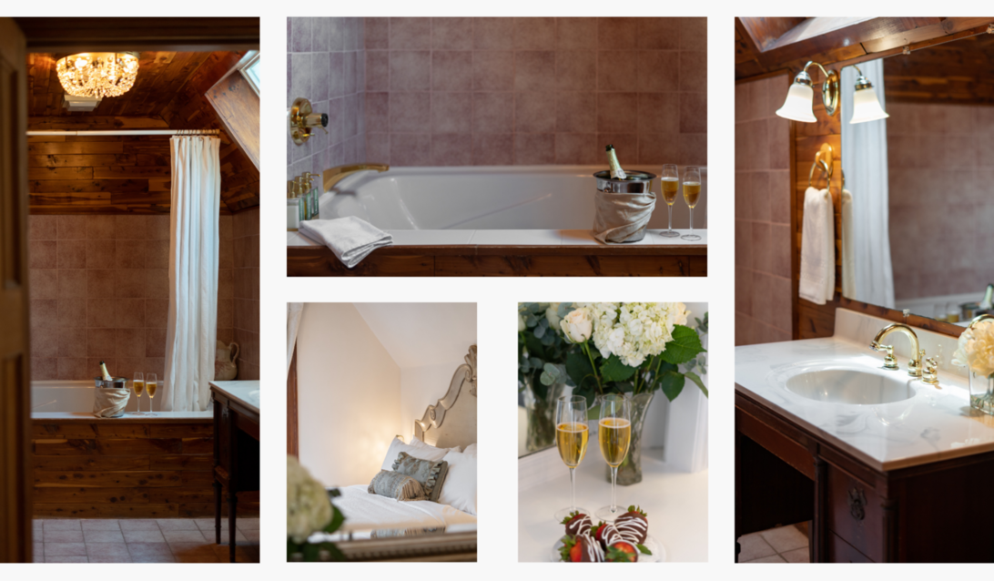 A bathroom with a bathtub , sink , mirror and flowers.