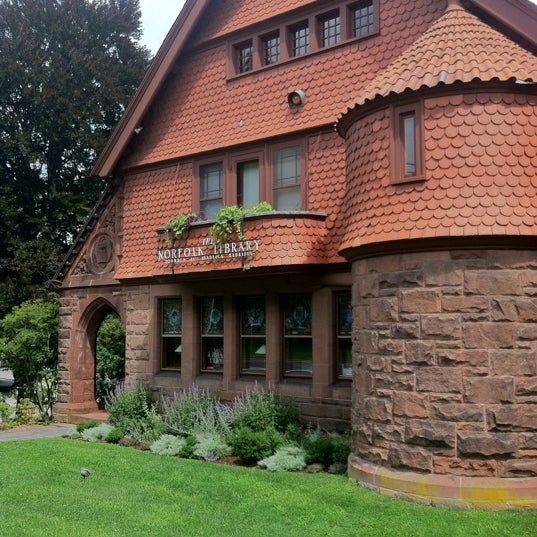 A large brick house with a red tile roof