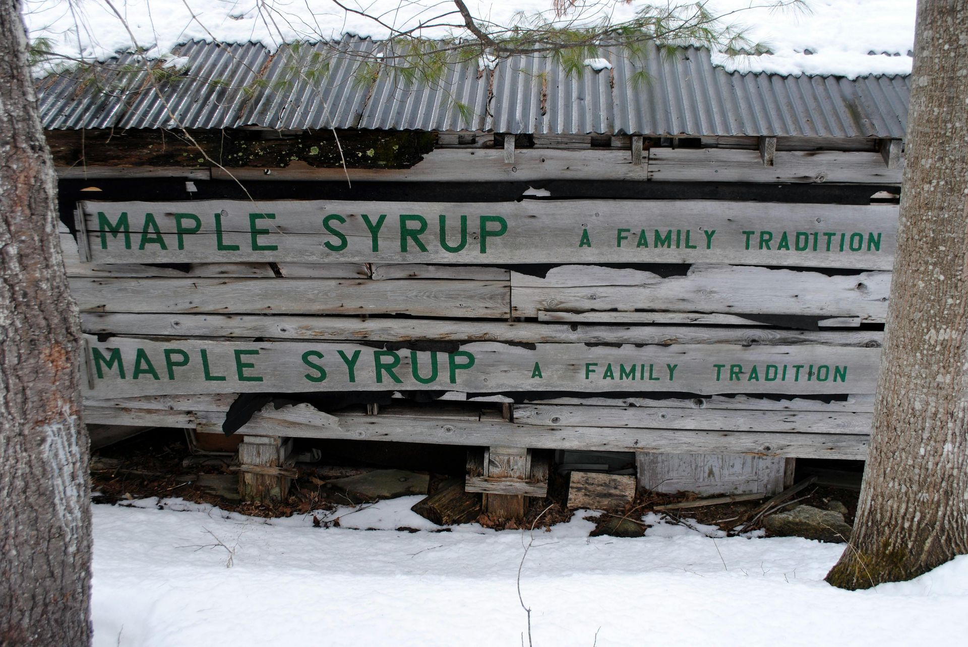 A wooden sign that says maple syrup on it