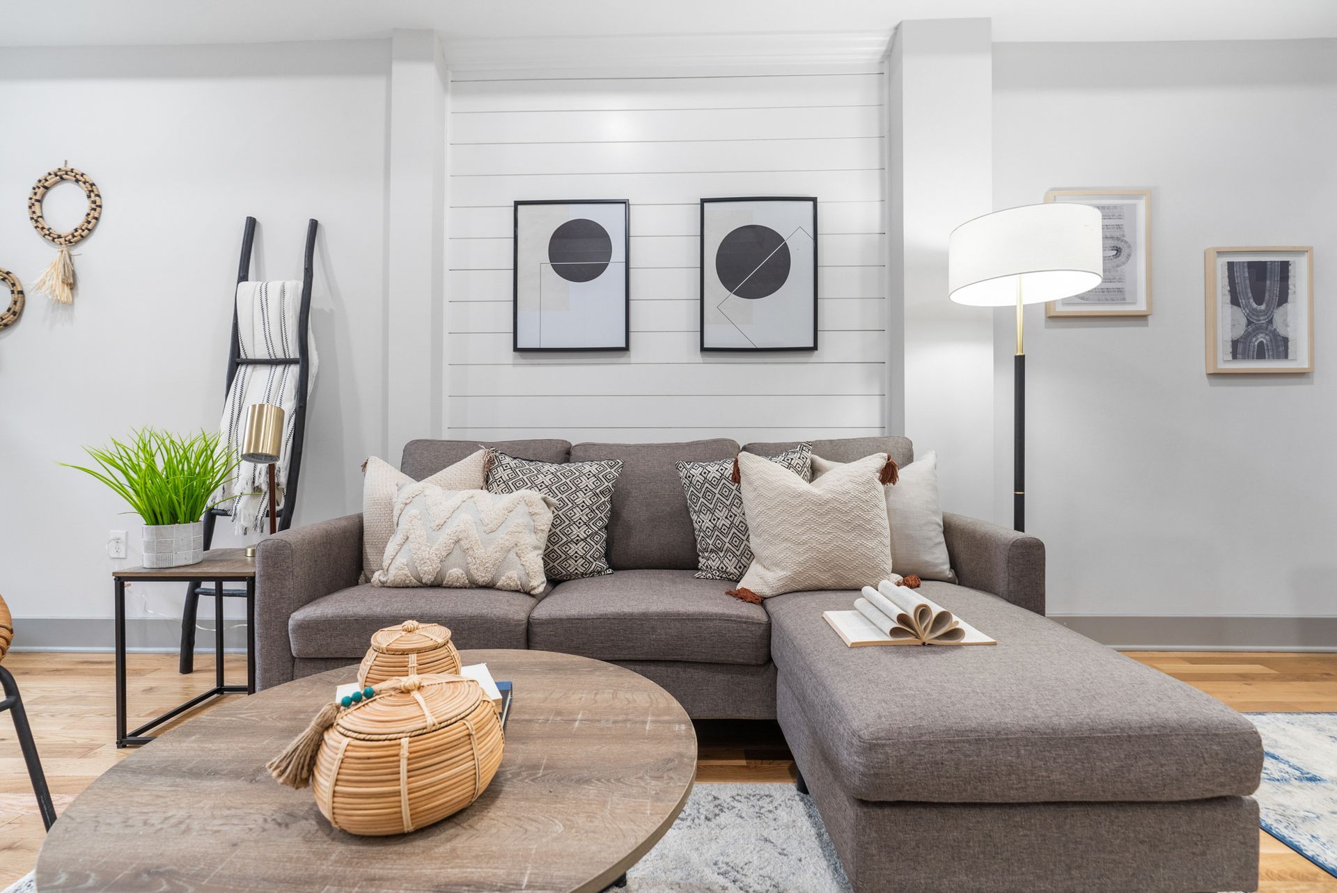 A living room with a couch , coffee table , and lamp.