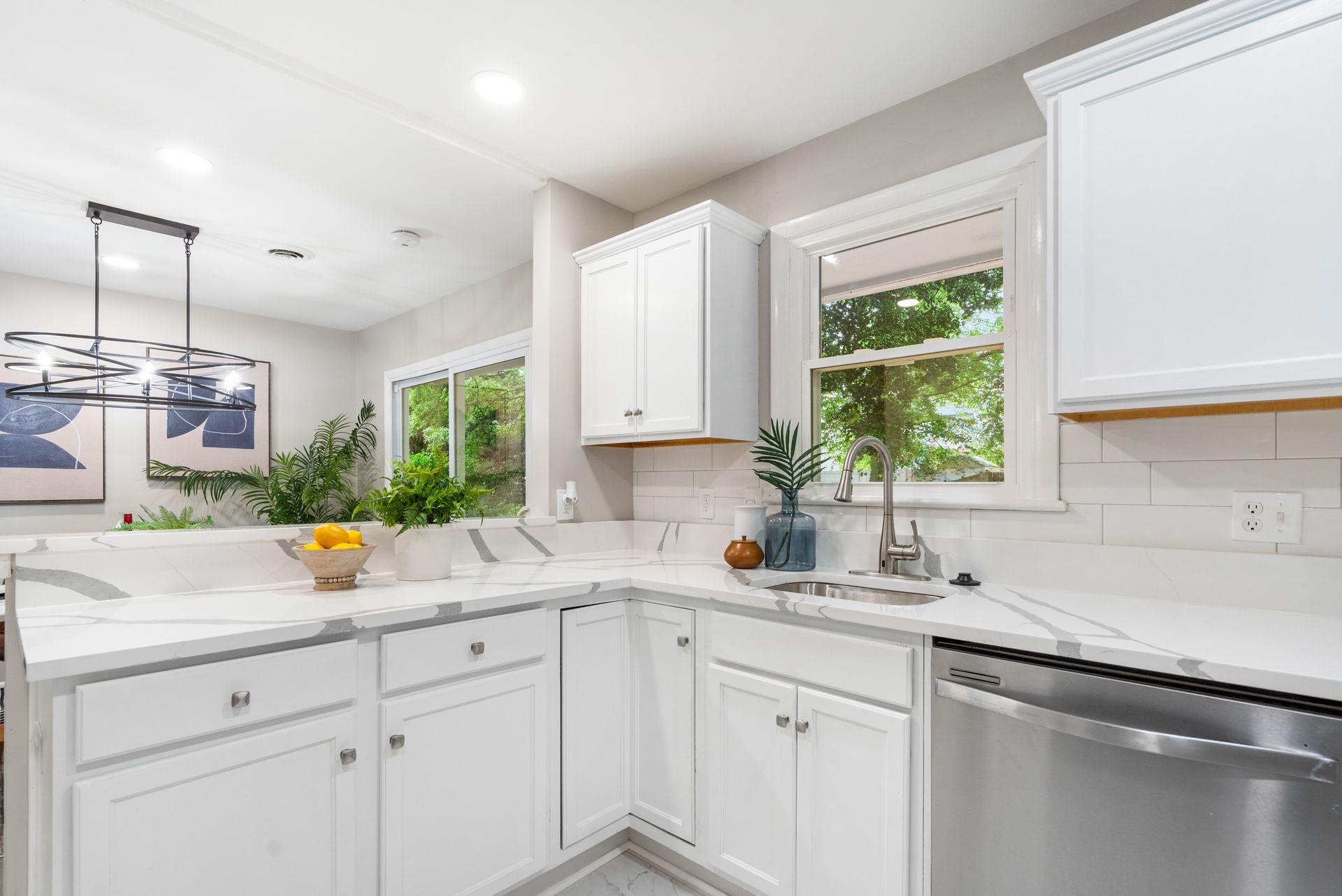 A kitchen with white cabinets and stainless steel appliances.
