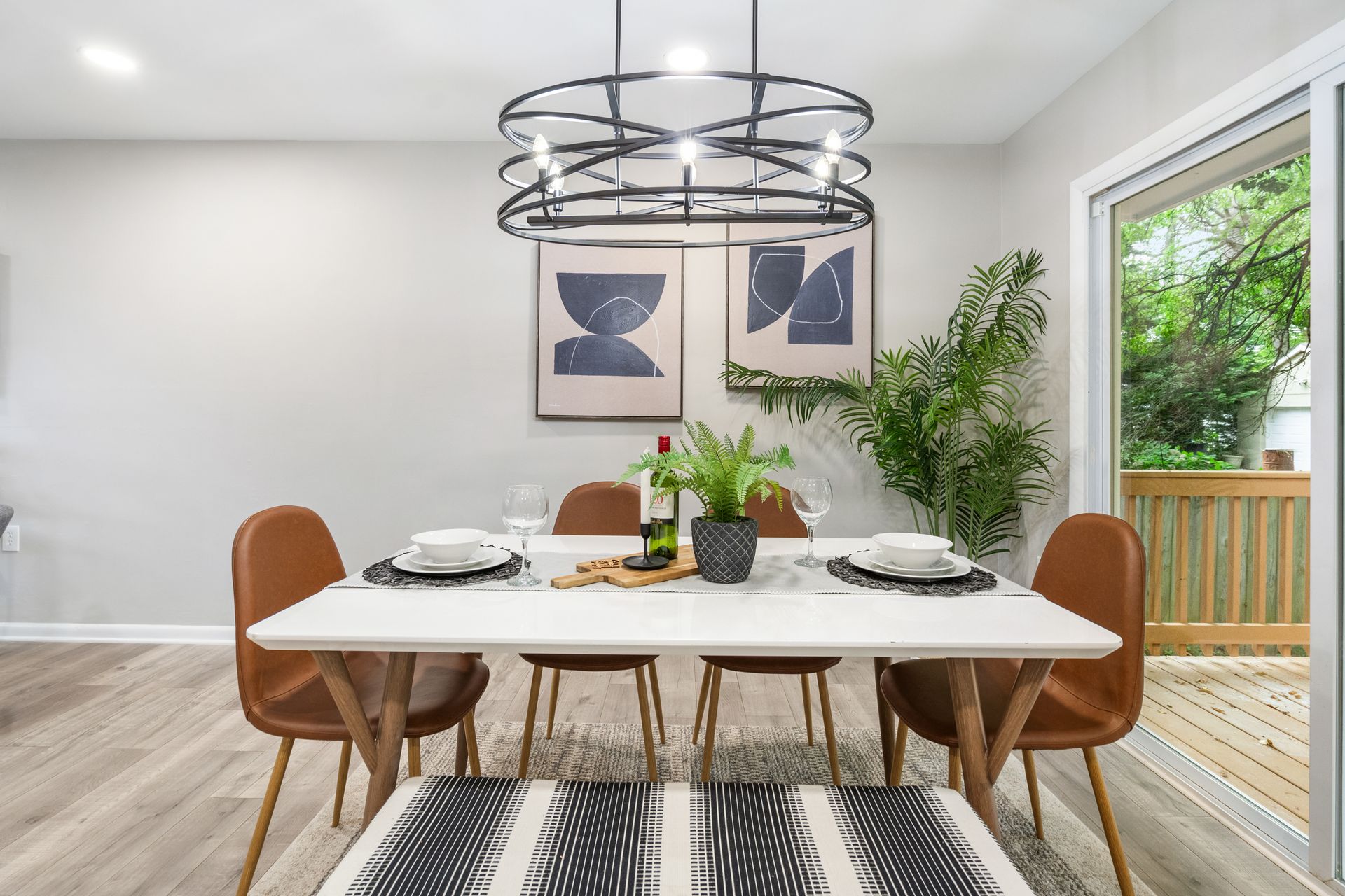 A dining room with a table and chairs and a chandelier.