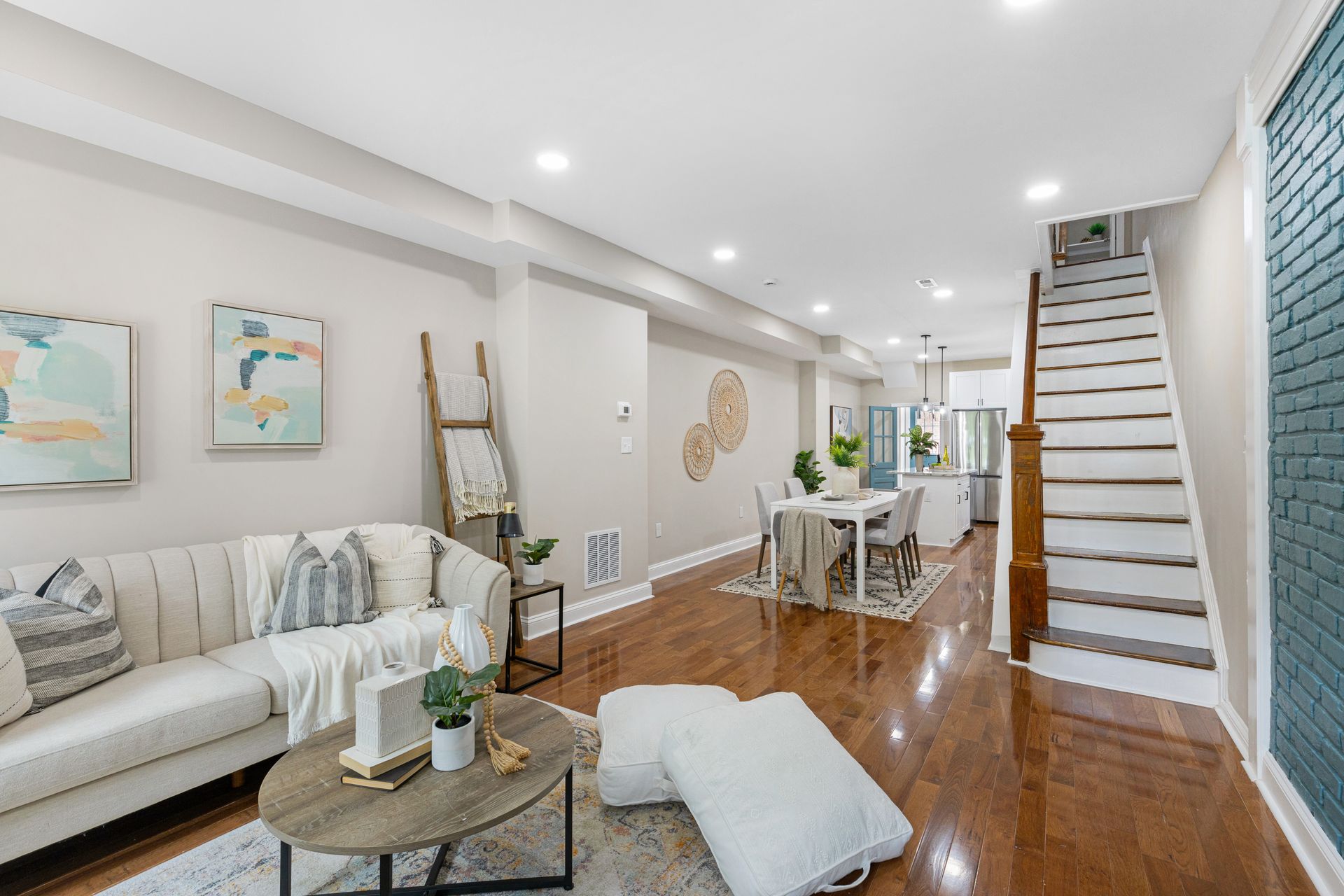 A living room with a couch , coffee table , and stairs.