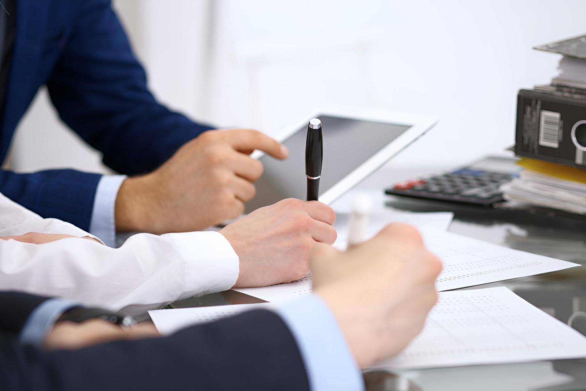 Group of People Are Sitting at a Table With Papers — Darling Downs Bookkeeping Company in Highfields, QLD