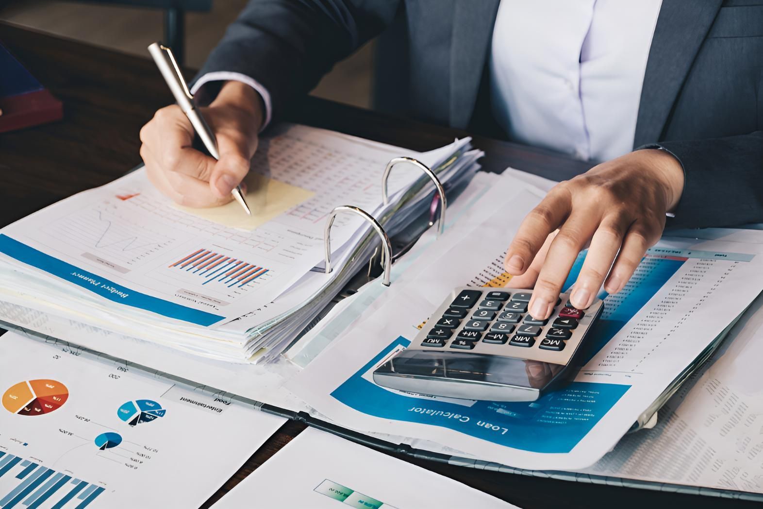 Woman is Using a Calculator — Darling Downs Bookkeeping Company in Highfields, QLD