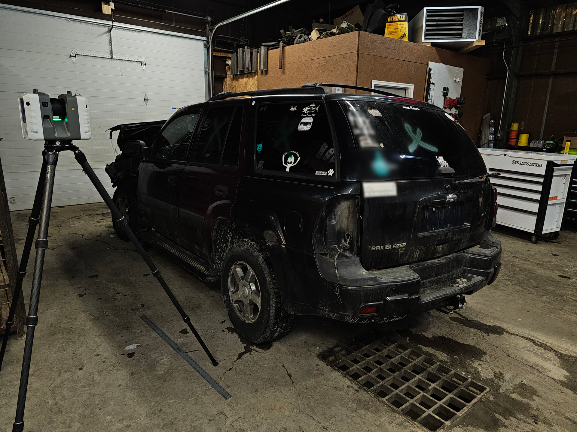 Forensic scan of a damaged vehicle in a garage
