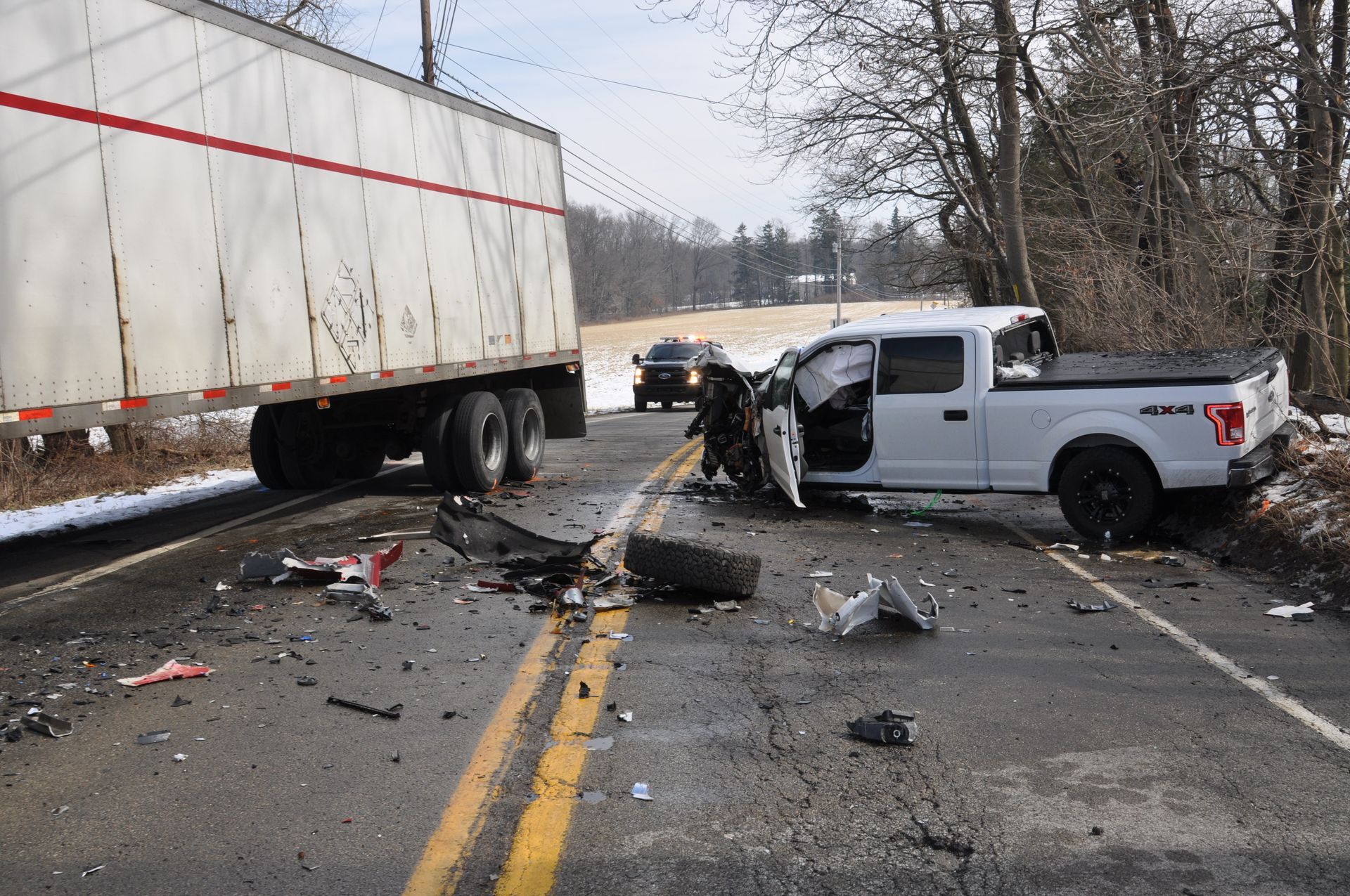 A crash scene involving a semi-truck and a pickup truck