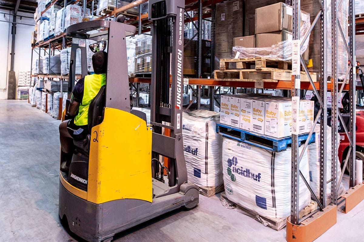 GO worker with forklift in warehouse