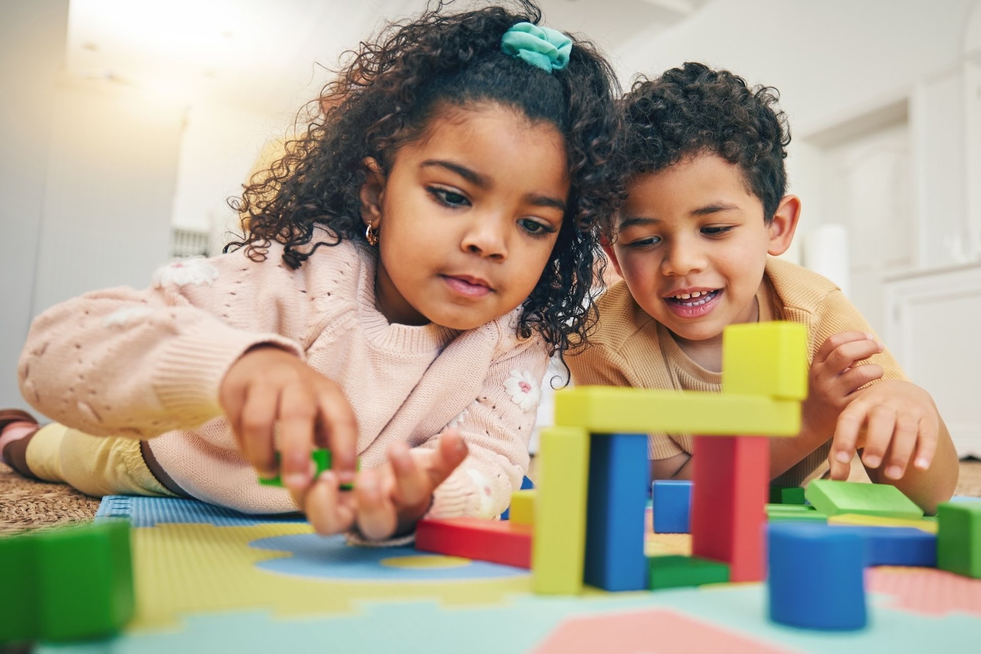 A montessori guide and a student are looking at a book together