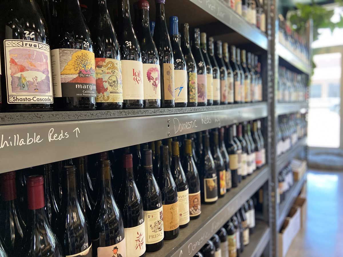 a shelf full of bottles of wine including shasta-cascade