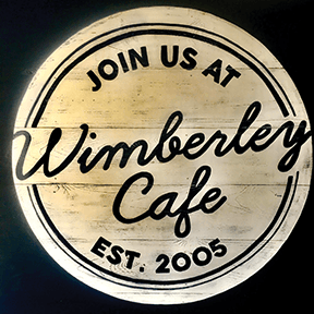 A sign that says join us at wimberley cafe