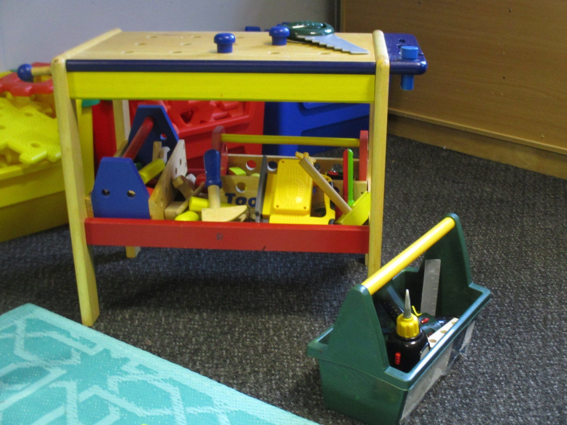 A toy workbench with a toolbox next to it