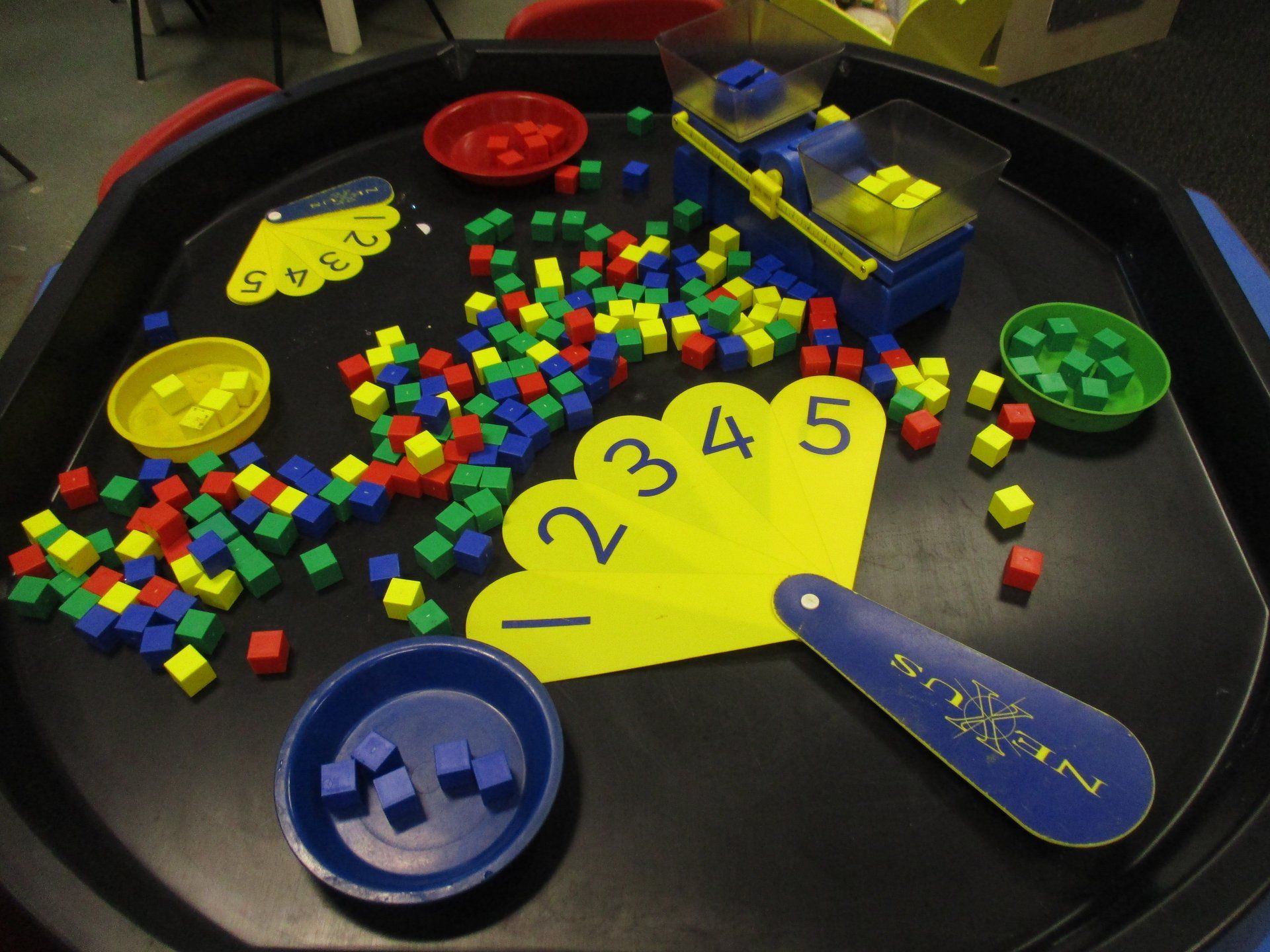 A table with a fan and numbers on it