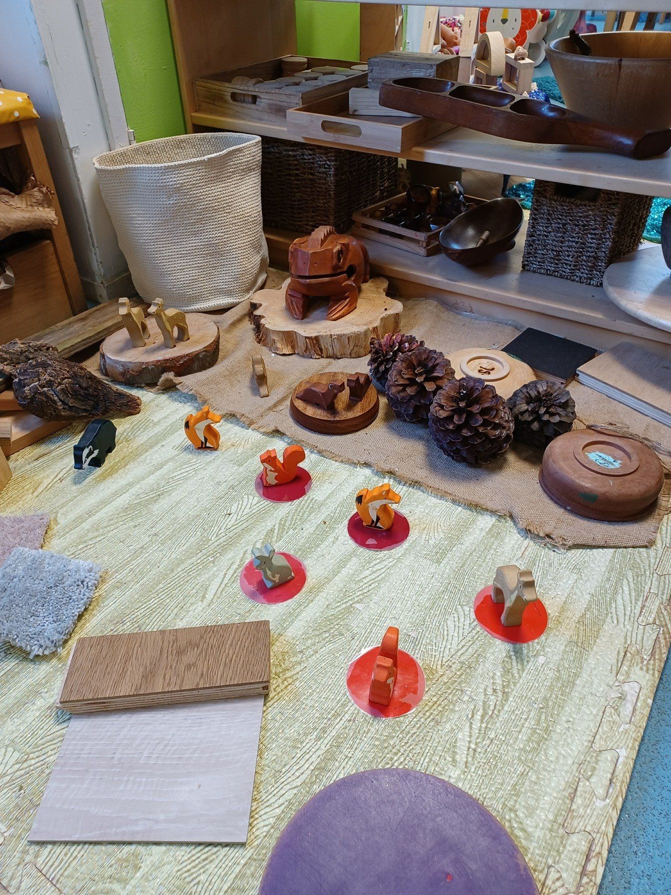 A table with a lot of wooden toys on it.