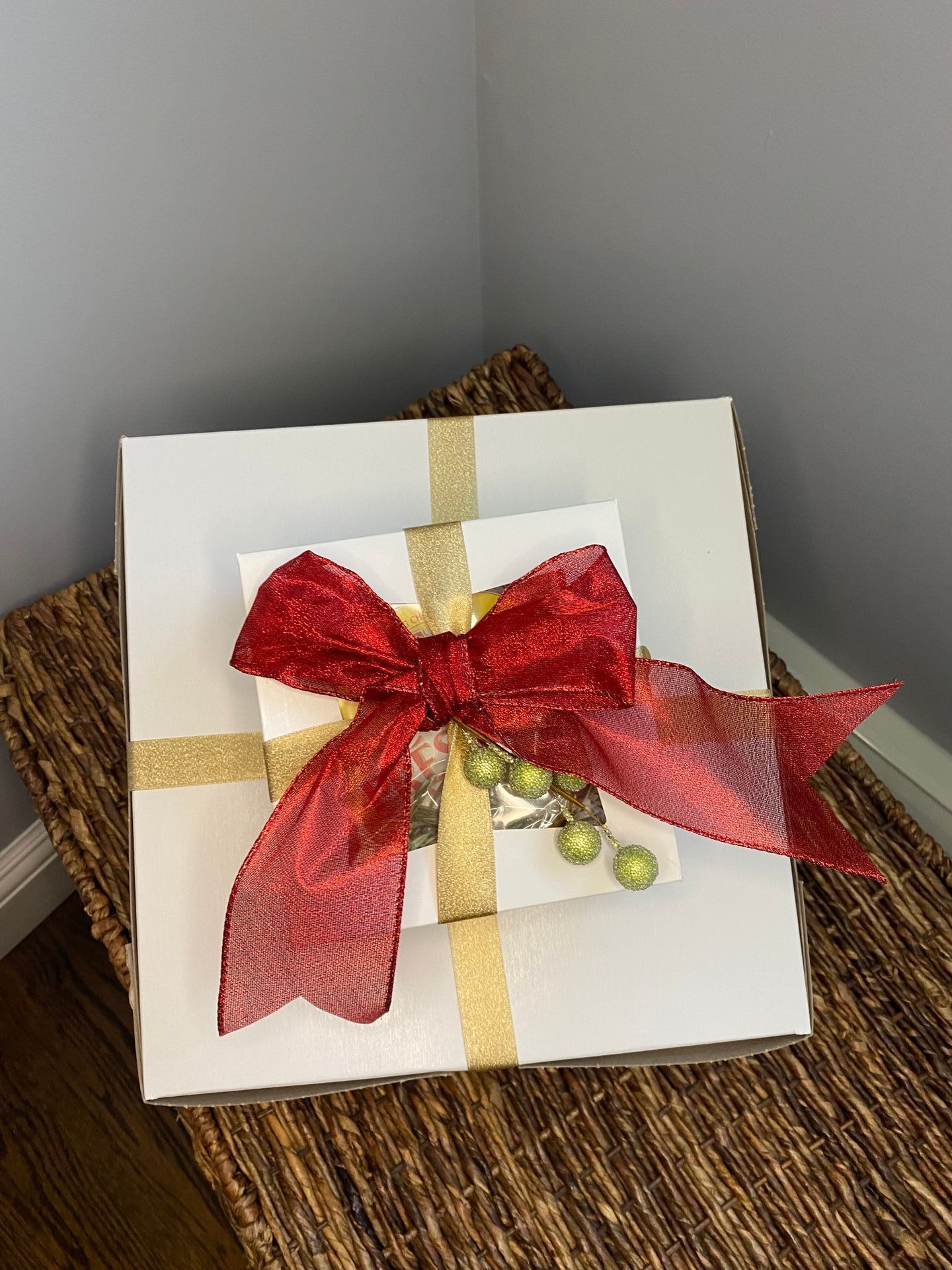 a white box with a red bow on top of it