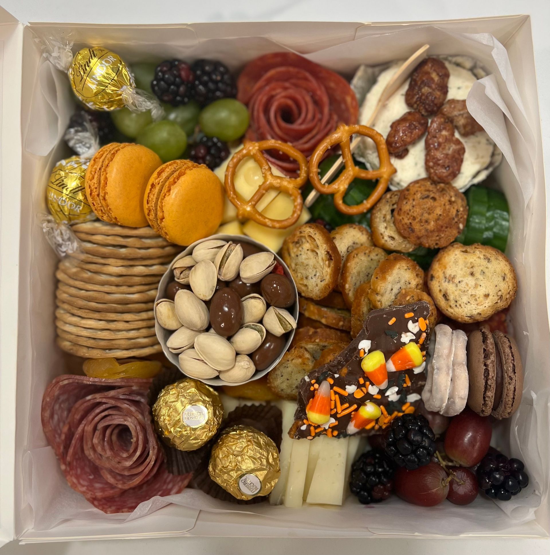 a box filled with a variety of food including candy corn