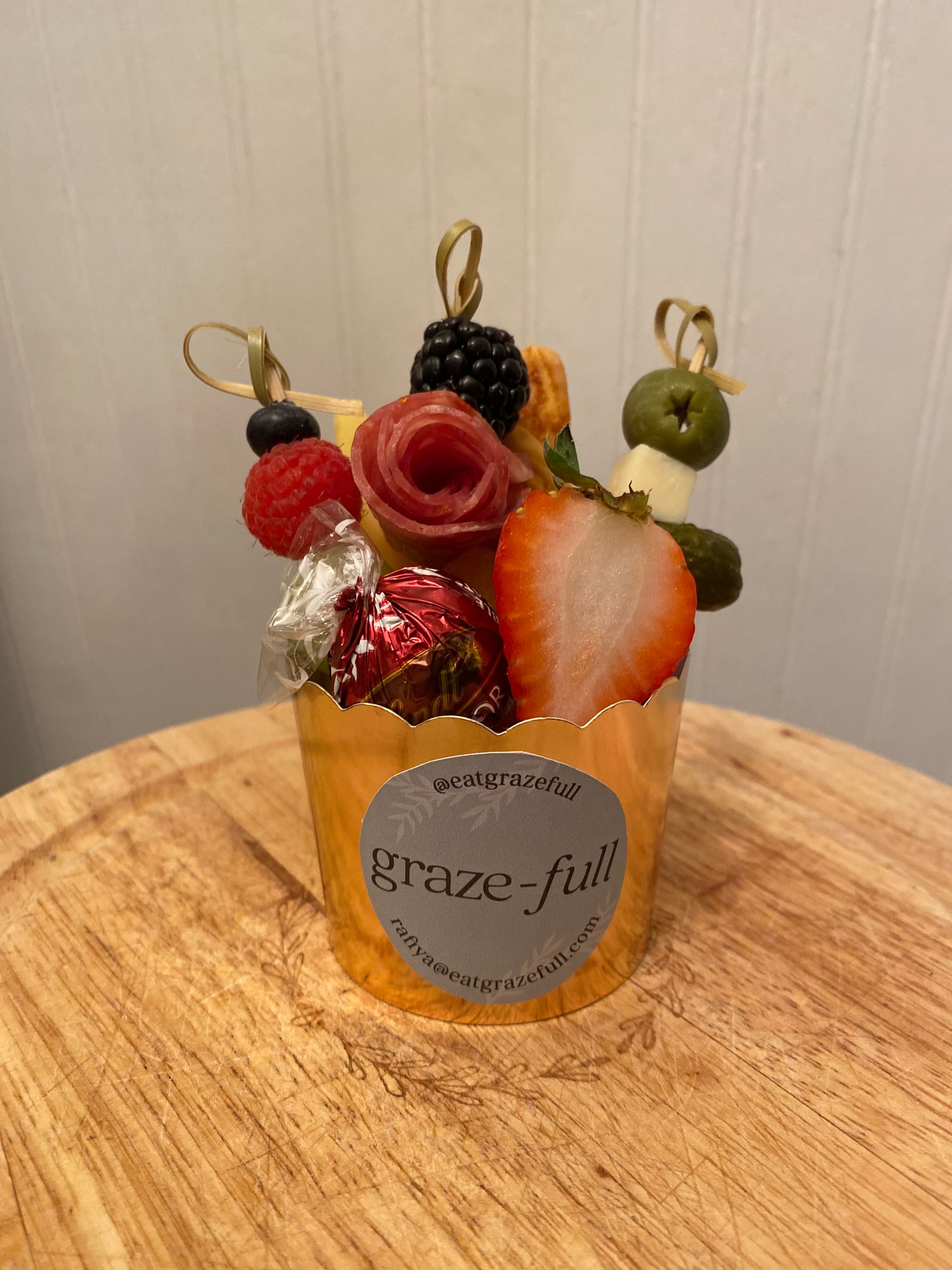 a graze-full cupcake with a sticker on it