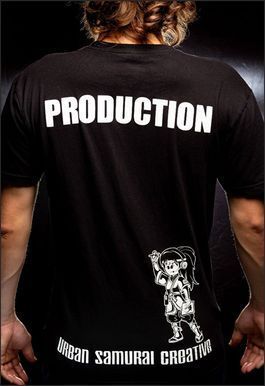 Man wearing black t-shirt. "PRODUCTION" printed on back. Graphic of girl and text "Urban Samurai Creative" at the bottom.