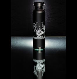 Black water bottle with etched Viking-themed design, reflecting on a glossy black surface.