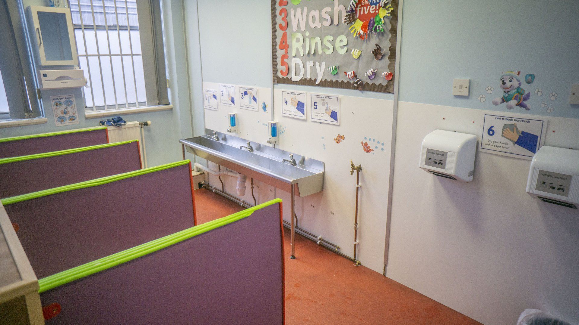 Childcare classroom with sinks, hand dryers, and 