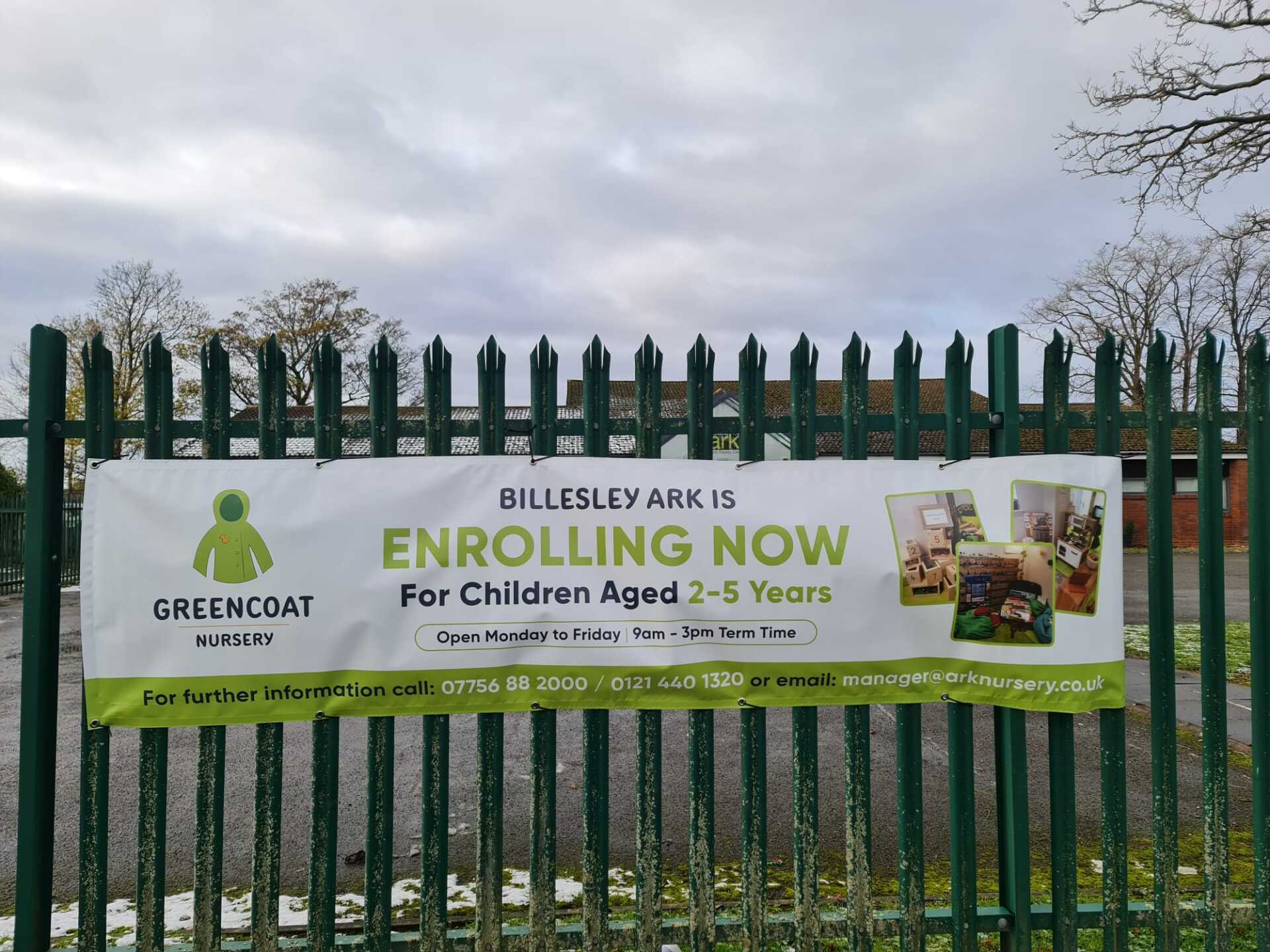 Banner on a green fence: 