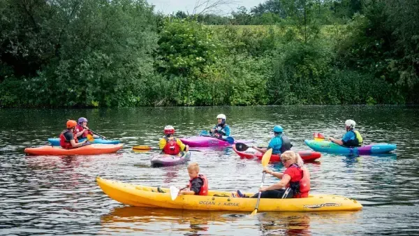 Paddler Northern Ireland | A group of people are riding kayaks on a lake.