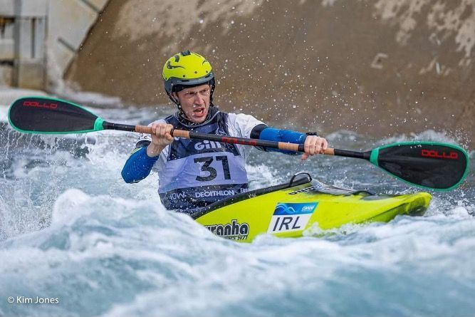 Paddle Northern Ireland | A man is paddling a kayak through a wave.