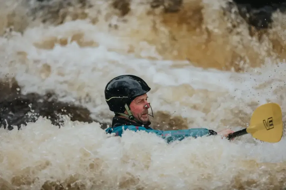 Paddler Northern Ireland | A man is riding a kayak down a river.