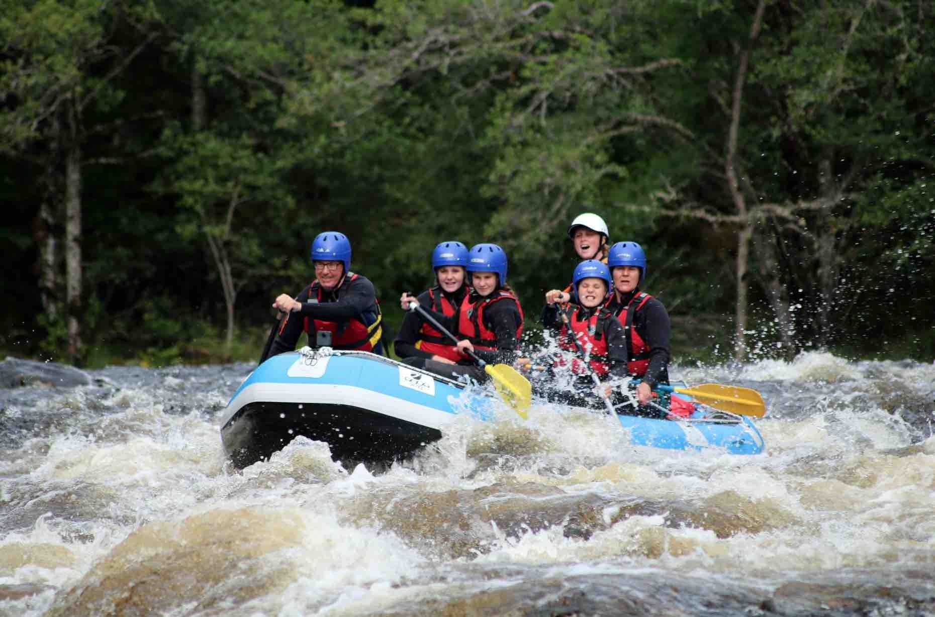 A group of people are rafting down a river.