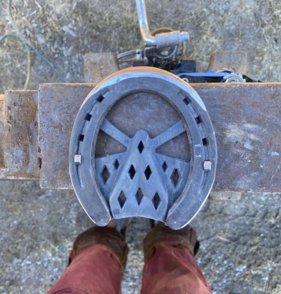 A person standing next to a horseshoe on a table
