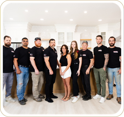 A group of people are posing for a picture in a kitchen.