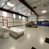 A large warehouse with a lot of foam on the floor.