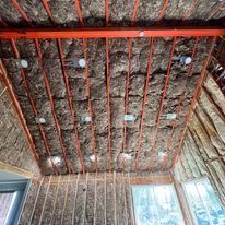 A room with a ceiling that is covered in insulation.