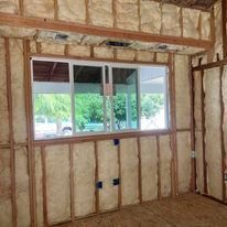 A room with a window and a lot of insulation on the walls.