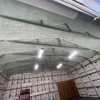 A large warehouse filled with lots of shelves and boxes.