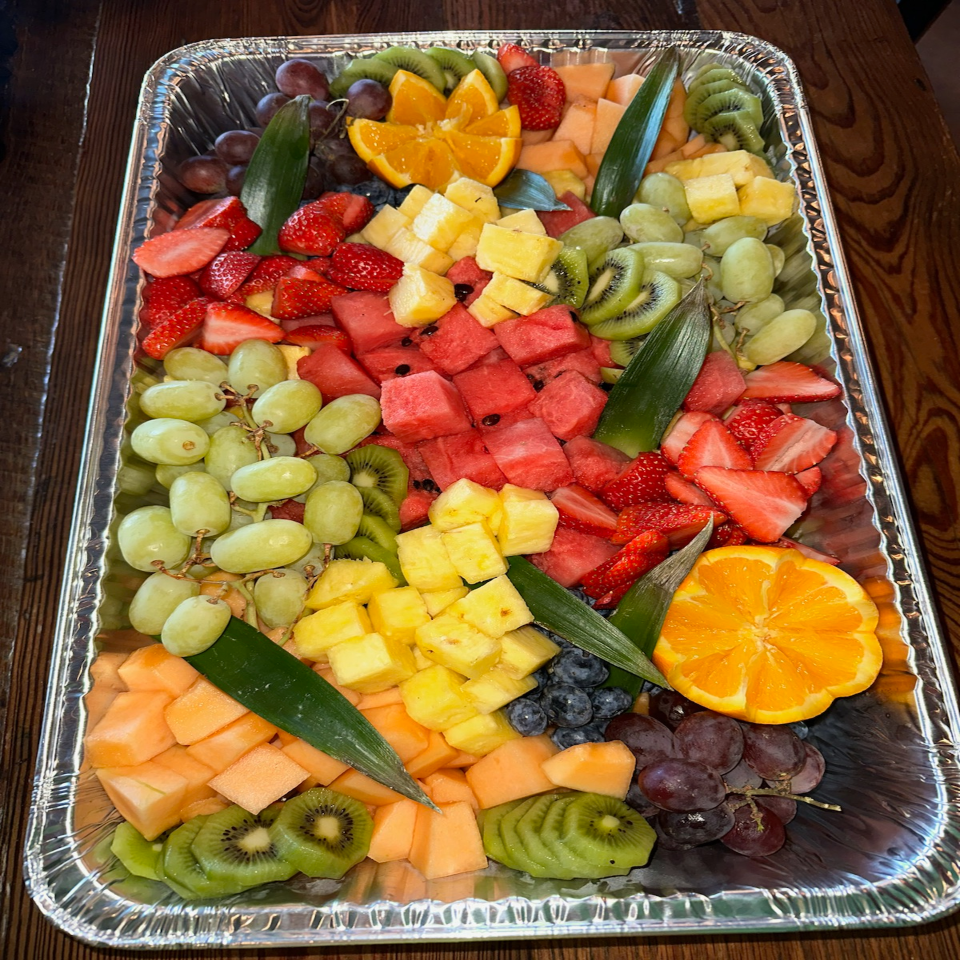a tray of pasta and broccoli is sitting on a table .
