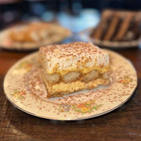 a slice of tiramisu is on a plate on a table