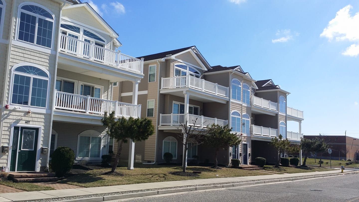 A row of apartment buildings with balconies on a sunny day