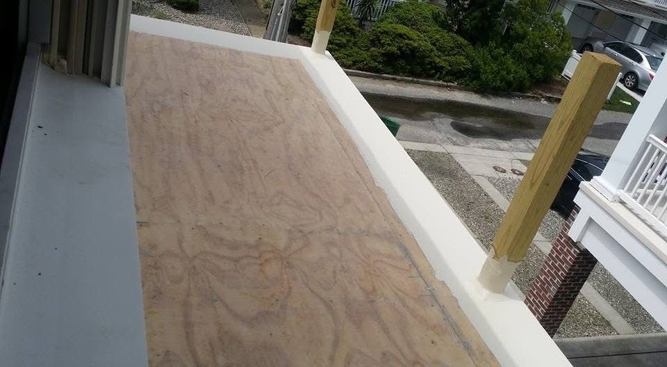 A balcony with a piece of plywood on it