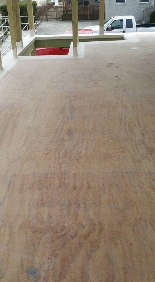 A wooden floor with a truck parked in the background