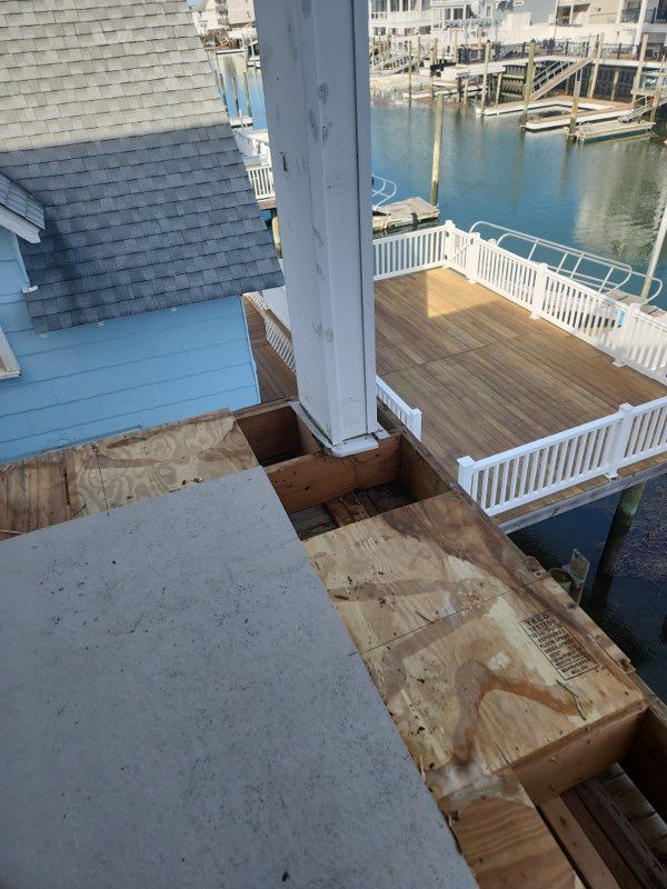 A wooden deck is being built next to a body of water