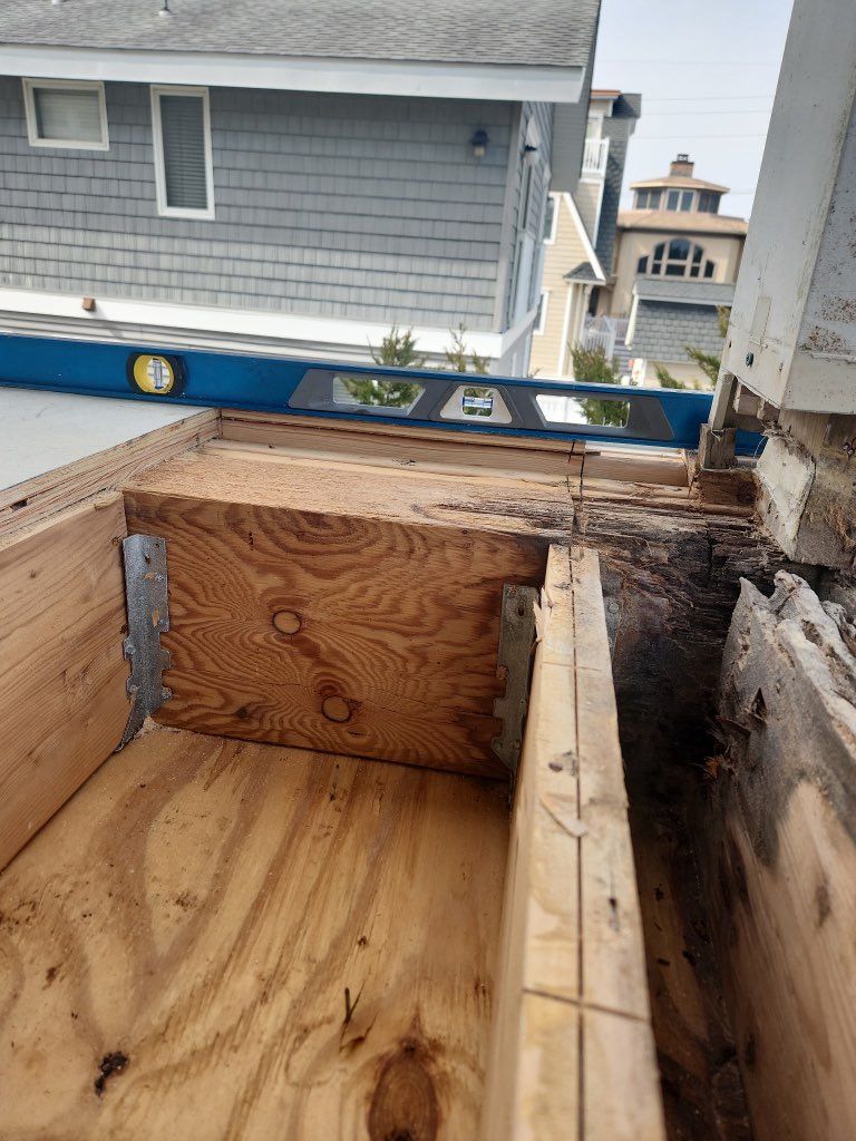 A blue level is sitting on top of a wooden box